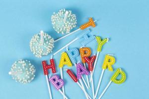 Cakes with rainbow-colored birthday candles with the inscription Happy Birthday photo