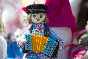 Ethnic toy of a musician with an accordion. photo