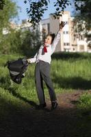 A happy schoolboy throws up his school backpack and rejoices at the start of the holidays. The end of the school year and the beginning of the holidays. photo