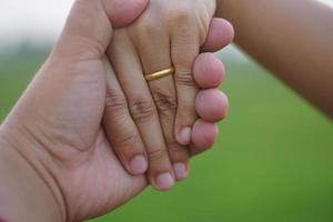 couple hands holding each other photo