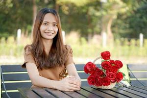 Asian woman sitting on table smiling happily photo