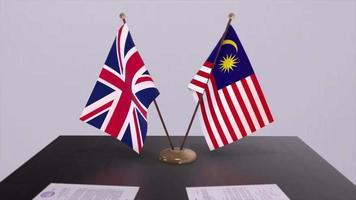 Malaysia and UK flag. Politics concept, partner deal between countries. Partnership agreement of governments video