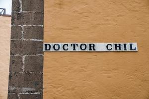 Close-up of doctor chil signboard on old wall of building in old town photo