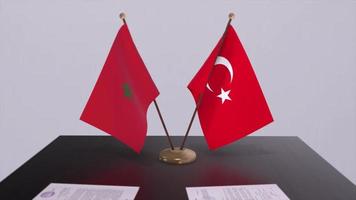Morocco and Turkey flags at politics meeting. Business deal video