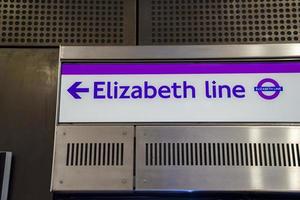 Elizabeth Line text with arrow symbol on metallic board at underground station photo