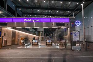 Entrance with Paddington text and escalators at underground subway station photo