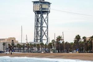 Torre Sant Sebastia and beach on a cloudy day at Catalonia in Barcelona photo