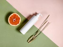 top view of plastic bottle, half of grapefruit photo