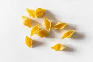 several dry uncooked conchiglie rigate pieces photo