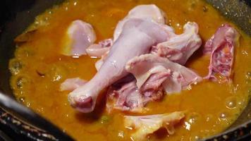 Cooking chicken curry in a cooking pan , video