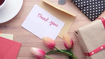 obrigado você mensagem, presente, e tulipas em a mesa video