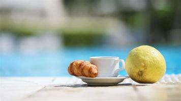Delicious breakfast lemon, coffee, croissant by the pool video