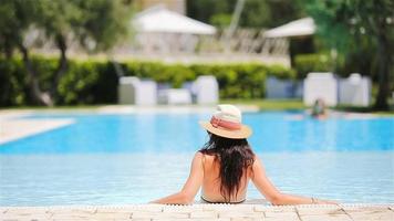Young woman in bikini in the big swimming pool video