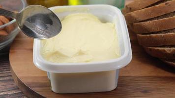 Salted butter in a container with bread on the table video