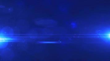 Abstract blue background from rays of light in the dark and optical flares. Video 4k
