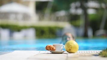 Delicious breakfast lemon, coffee, croissant by the pool video