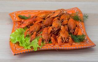 Boiled crayfish on wood photo