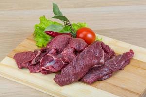 Raw venison on wood photo