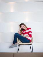 relaxed young woman at home working on laptop photo