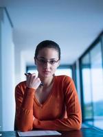 relaxed young woman at home working on laptop computer photo