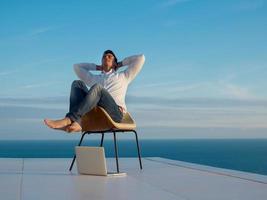 relaxed young man at home on balcony photo