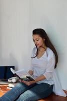 mujer joven relajada en casa trabajando en una laptop foto