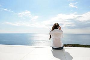 girl listening to the music on white headphones photo