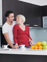 young couple have fun in modern kitchen photo