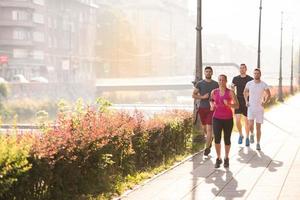 group of young people jogging in the city photo