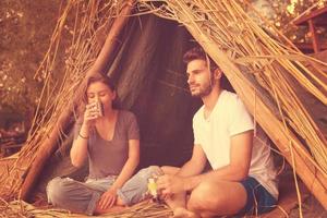 couple spending time together in straw tent photo