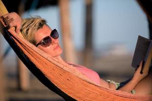 relaxed woman laying in hammock photo