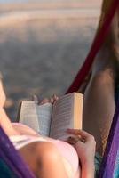 relaxed woman laying in hammock photo