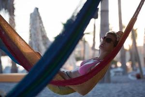 relaxed woman laying in hammock photo