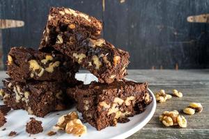 stack of homemade Walnut and chocolate brownies on plate photo