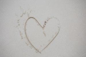 Heart drawn on sand photo