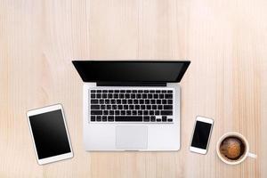 Top view laptop computer or notebook,mobile phone and cup of coffee on wooden table. Business template mock up for adding your text. photo