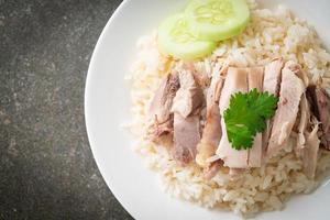 Hainanese Chicken Rice or steamed rice with chicken photo