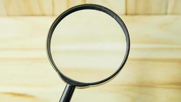 a  Magnifying glass on wood background image. photo