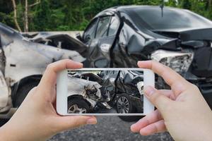 woman using smartphone take photo of car crash accident on the road