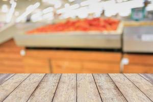 Empty wood table top with Supermarket blurred background photo