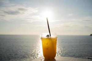 Close-up Cup orange juice table seaside sunset sky photo