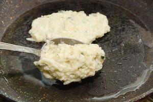 Recipe for zucchini fritters. Step 4 - Putting dough on  hot pan with oil. photo