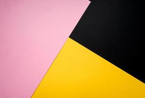 Minimalist concept, abstract colored paper geometry background, flat lay top view, multicolored empty image with copy space for any design purposes, bright yellow, bright pink, simple black photo