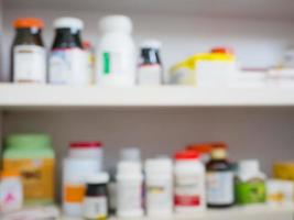 Close up of medicine bottles on shelves of drugs in the pharmacy photo