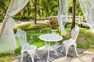 White decorated chair for relaxing in the coconut grove. photo