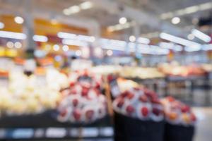 Grocery store with fresh fruits and vegetables shelves in supermarket blur background photo