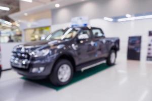 blur row of new car at car showroom dealership abstract defocused background photo