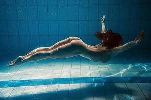 athletic sport woman underwater in the swimming pool photo