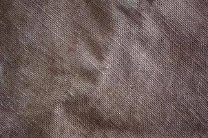 The texture of a very old brown sack cloth. Retro texture with canvas material. Background image with copy space photo