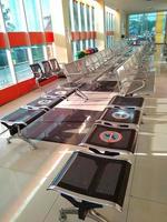 Iron chairs, in the hospital lobby. The seats are affixed with information stickers to maintain distance to prevent covid-19 infection. photo